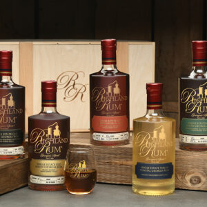 A group of bottles and cups sitting on top of a table.