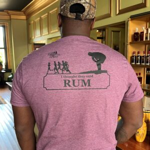 A man wearing a shirt with the words " I thought they said rum "