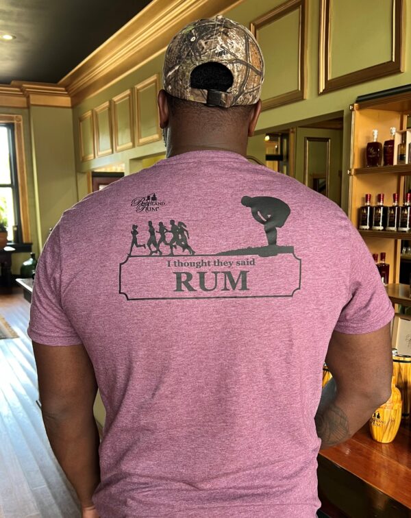A man wearing a shirt with the words " I thought they said rum "