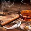 A snifter with rum and acigar